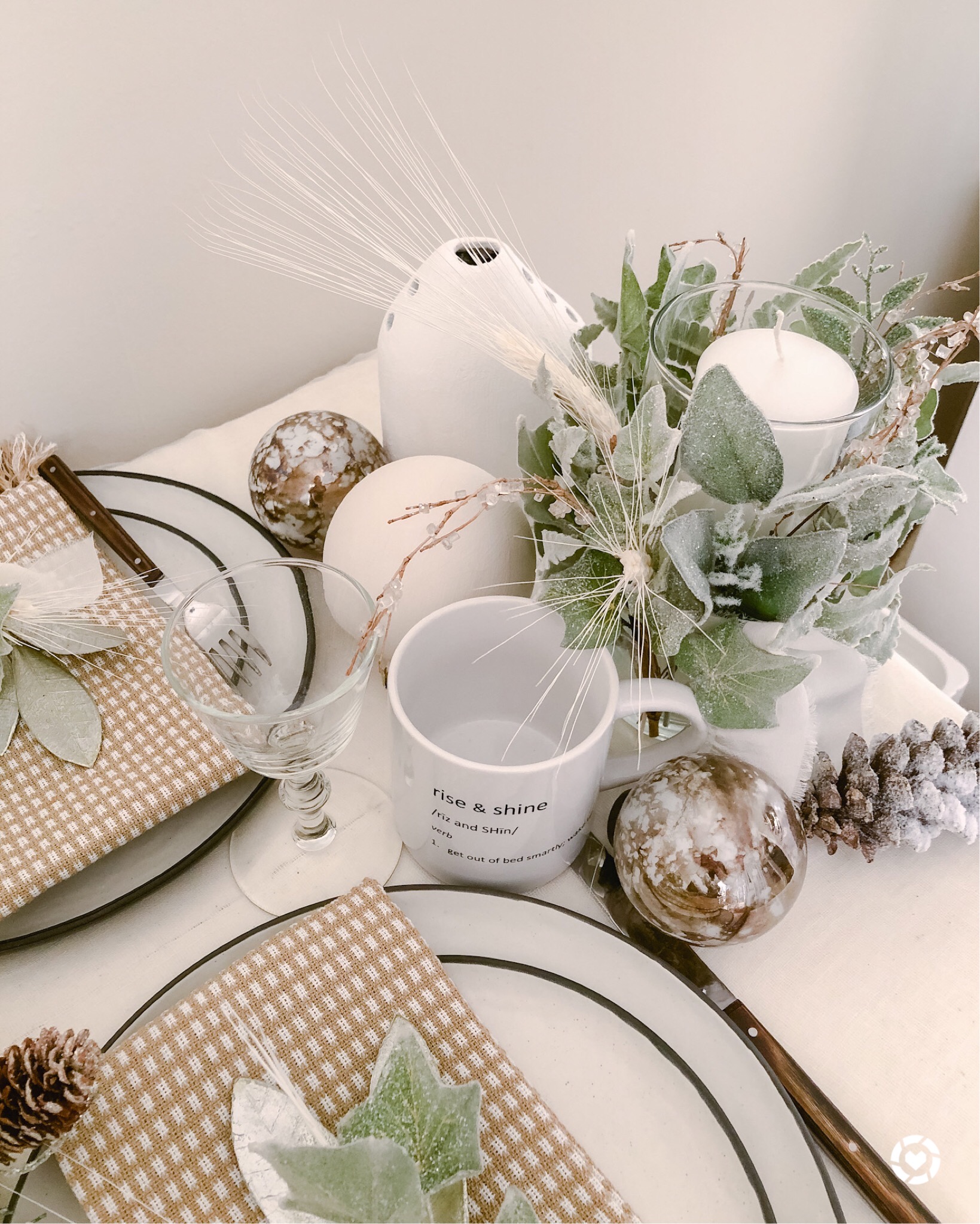 Create a wintry tablescape with white plates and napkins.